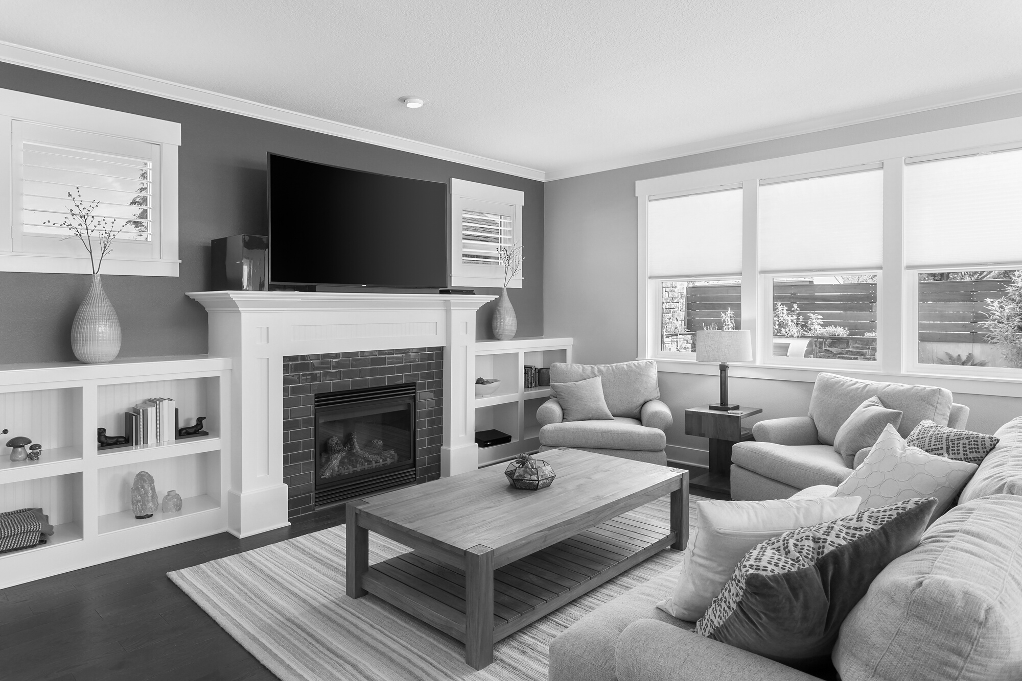 Beautiful living room interior with hardwood floors and fireplace in new luxury home.